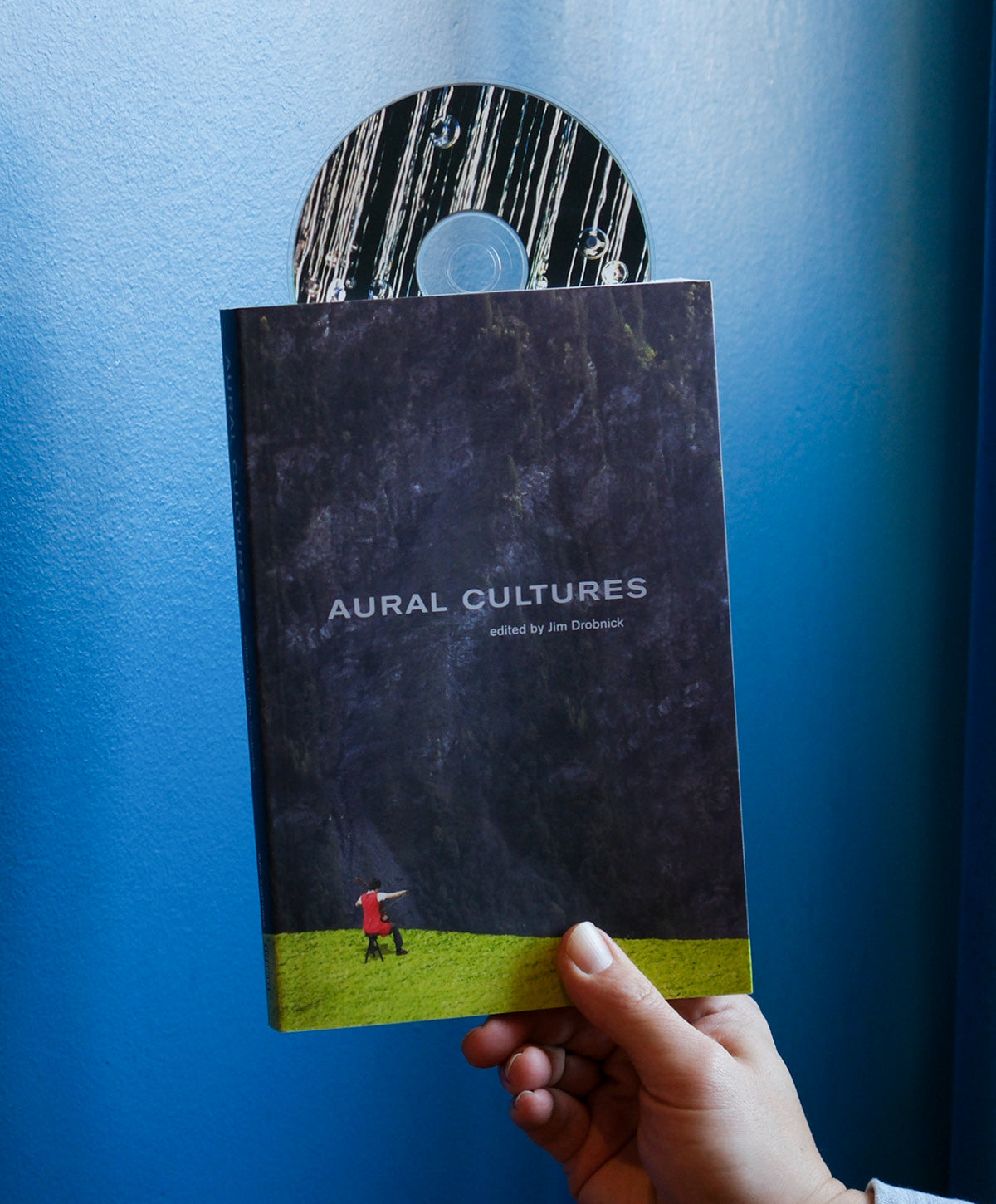 Book titled 'Aural Cultures' held against a blue background