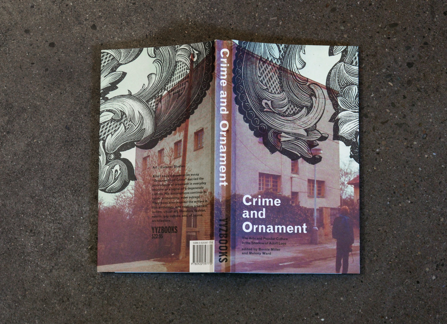 Book titled 'Crime and Ornament' on a textured surface