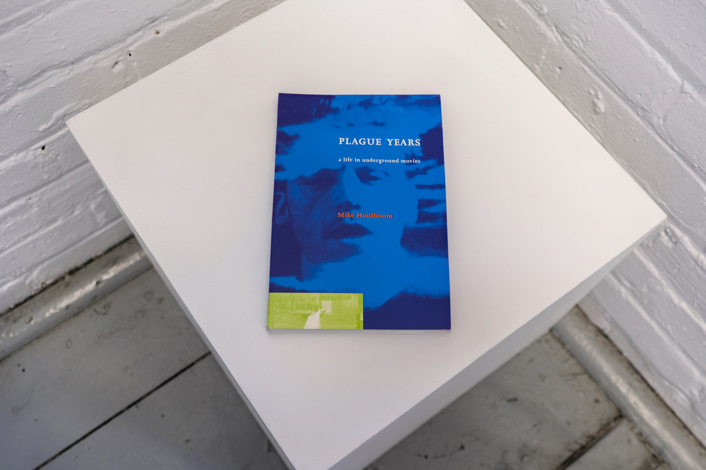 Book titled 'Plague Tears' on a white surface with a gray textured background