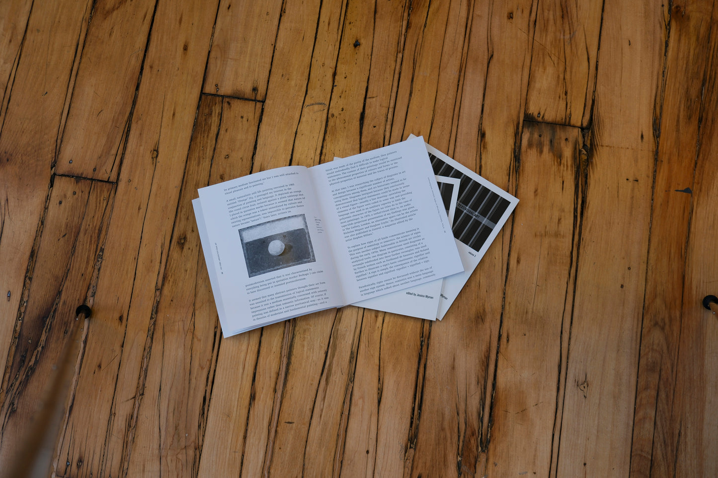 Open book and pages on a wooden surface