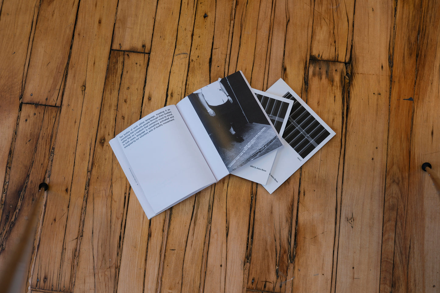Open book with black and white pages on a wooden surface
