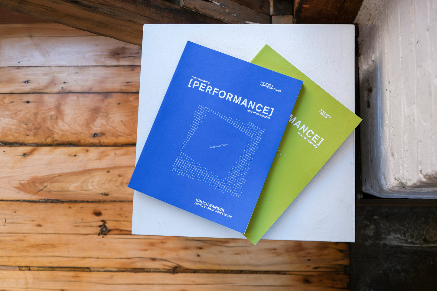 A blue and green book on a plinth