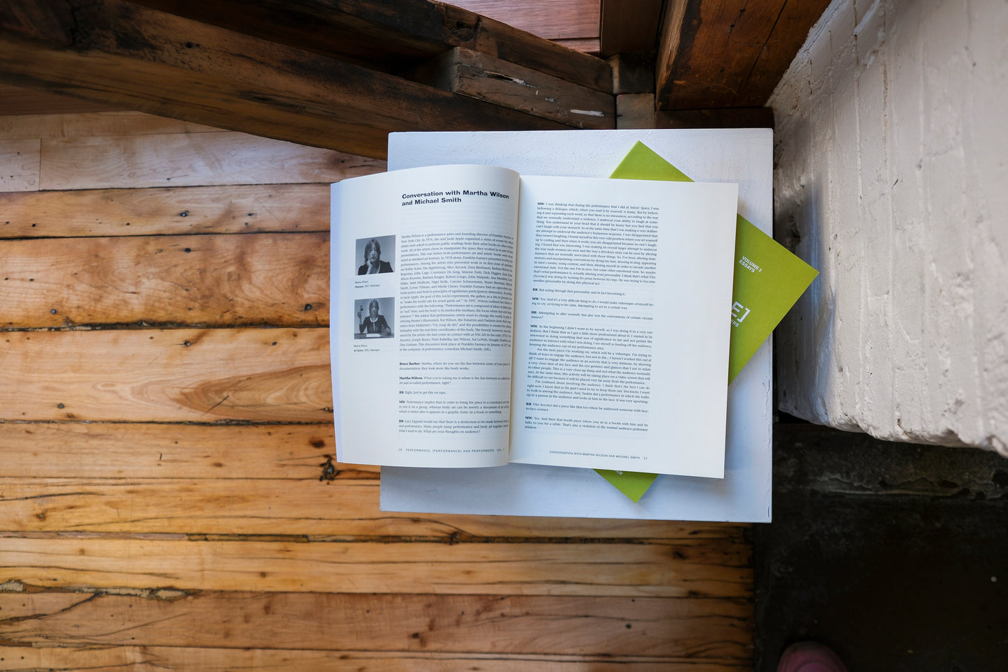 Open book on a plinth with a wooden surface