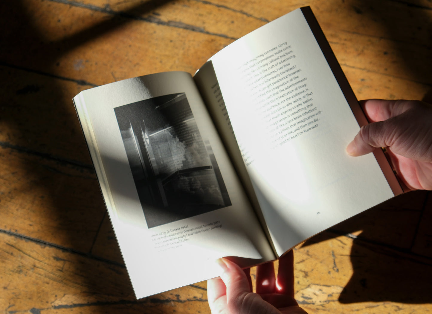 Open book with black and white photograph on a wooden surface