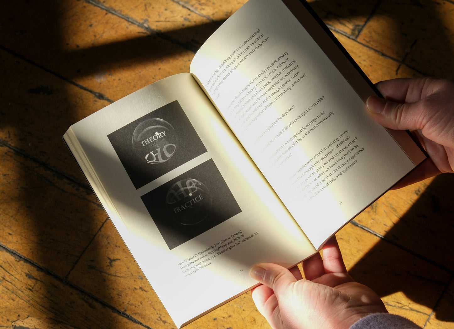 Open book with visible text and logos on a wooden surface