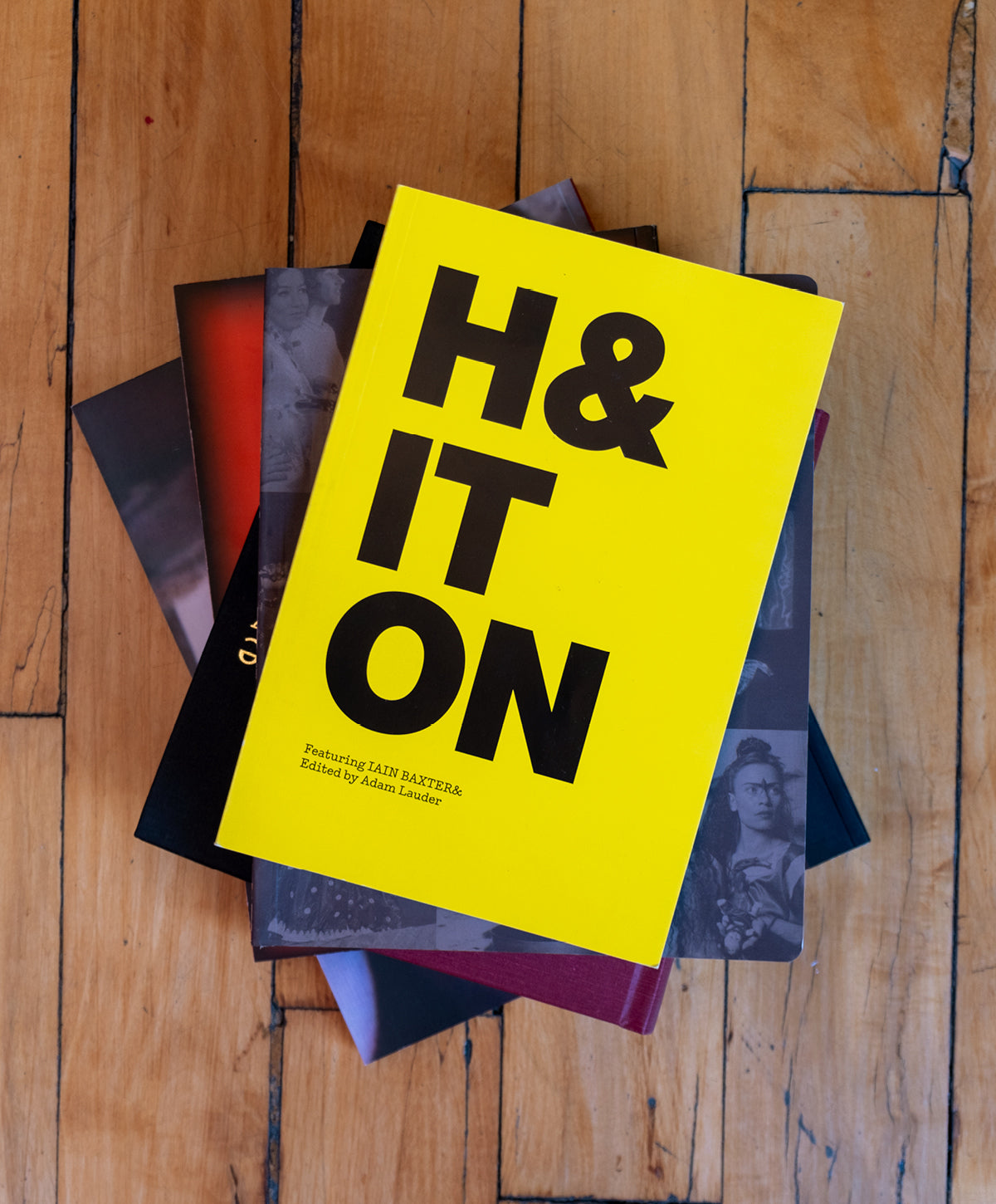 H& IT ON cover on a stack of books