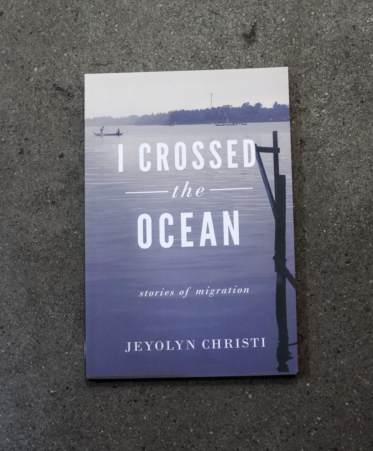 Book titled 'I Crossed the Ocean' by Jeyolyn Christi on a textured surface