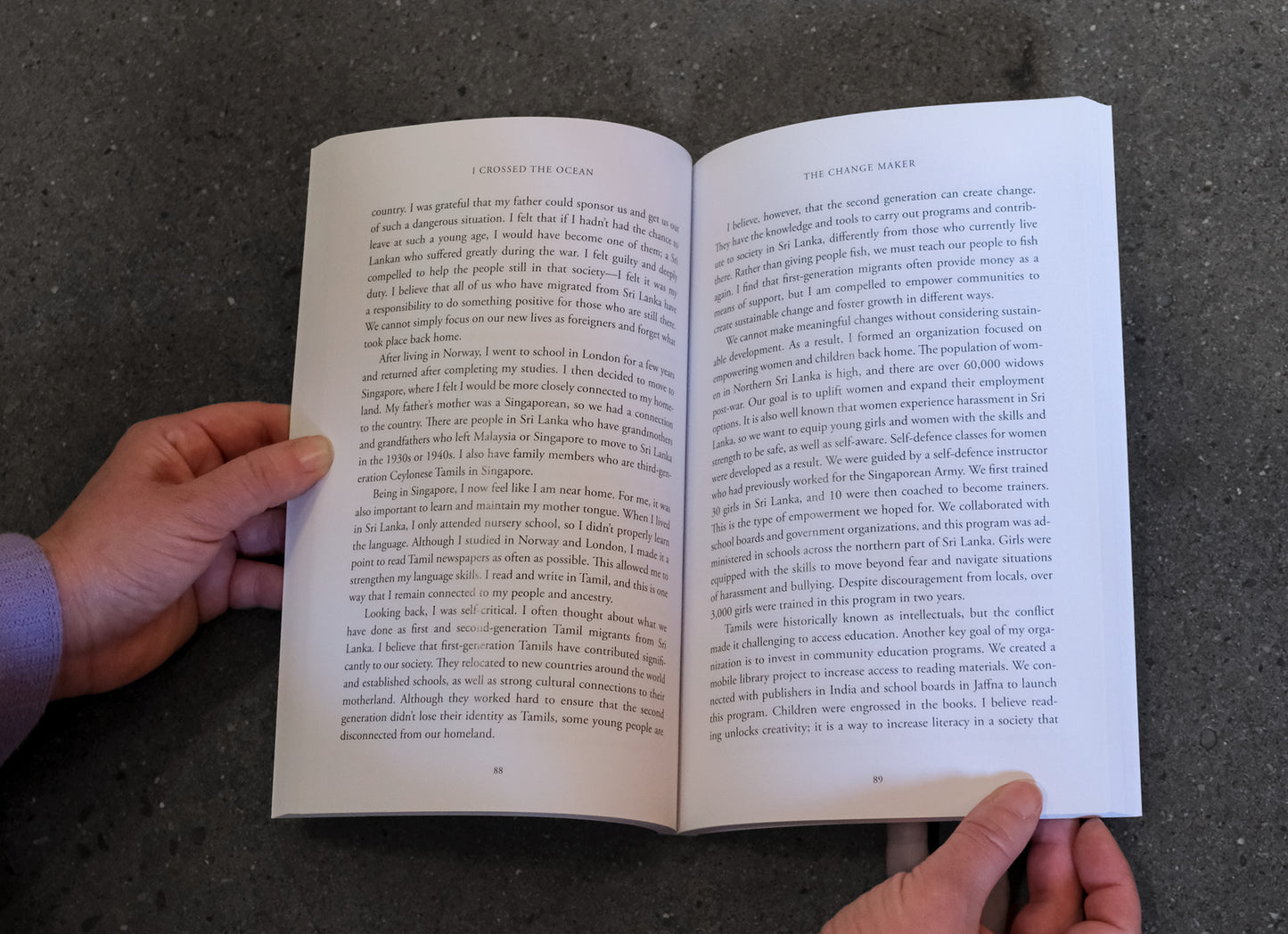 Open book held by a person against a dark background