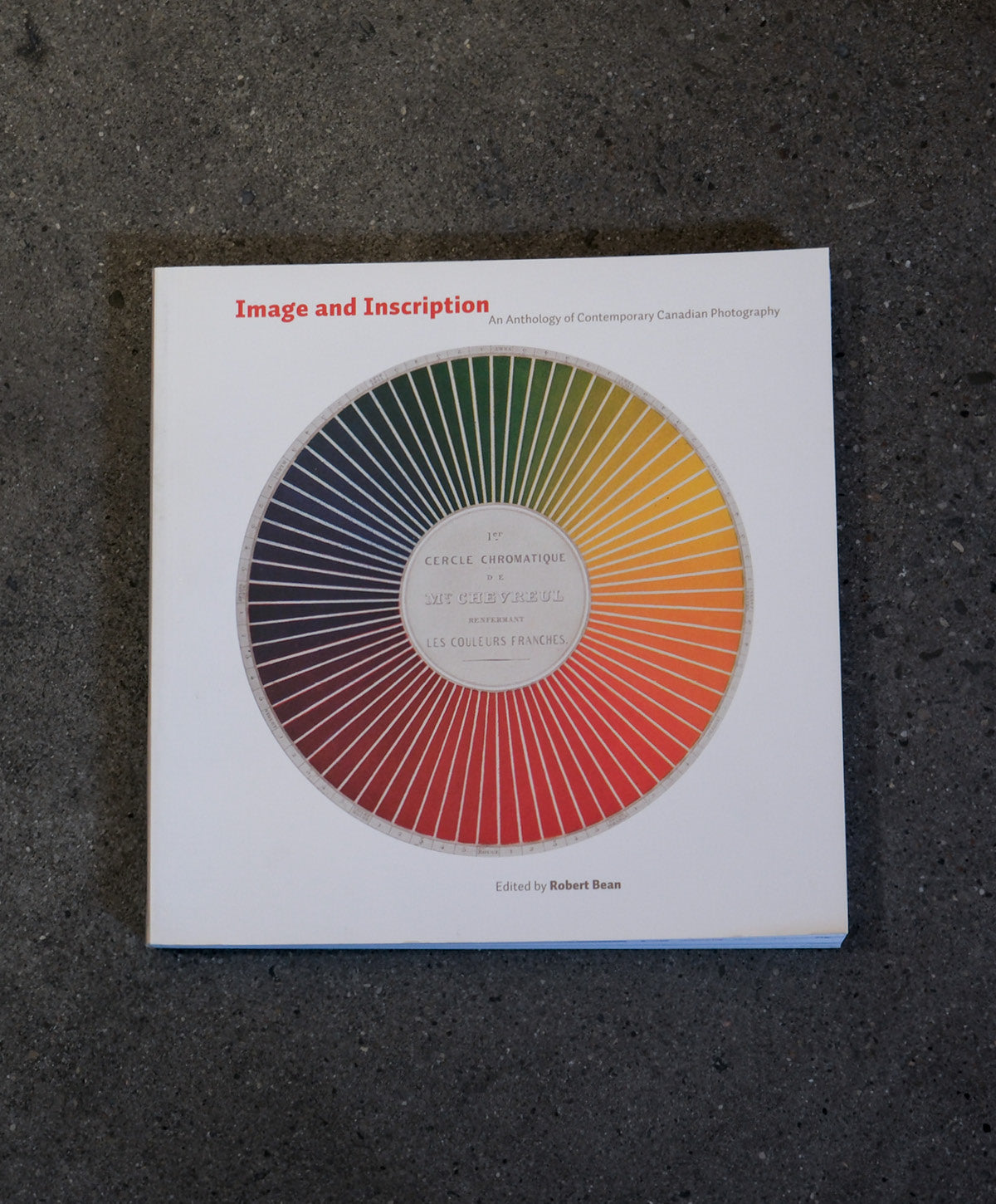 Book titled 'Image and Inscription' with a color wheel design on a dark textured surface
