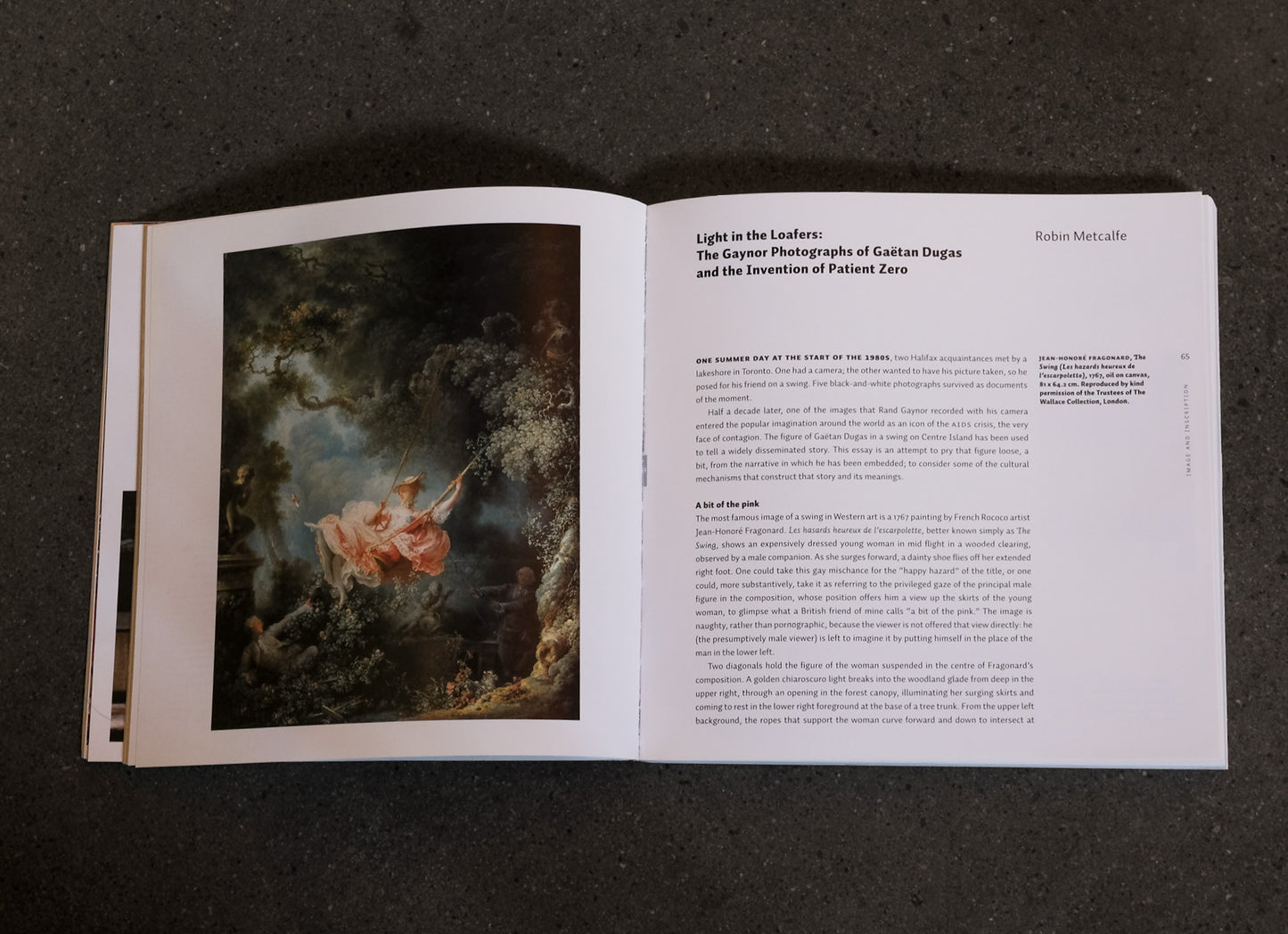 Open book with a painting on the left page and text on the right page against a dark background