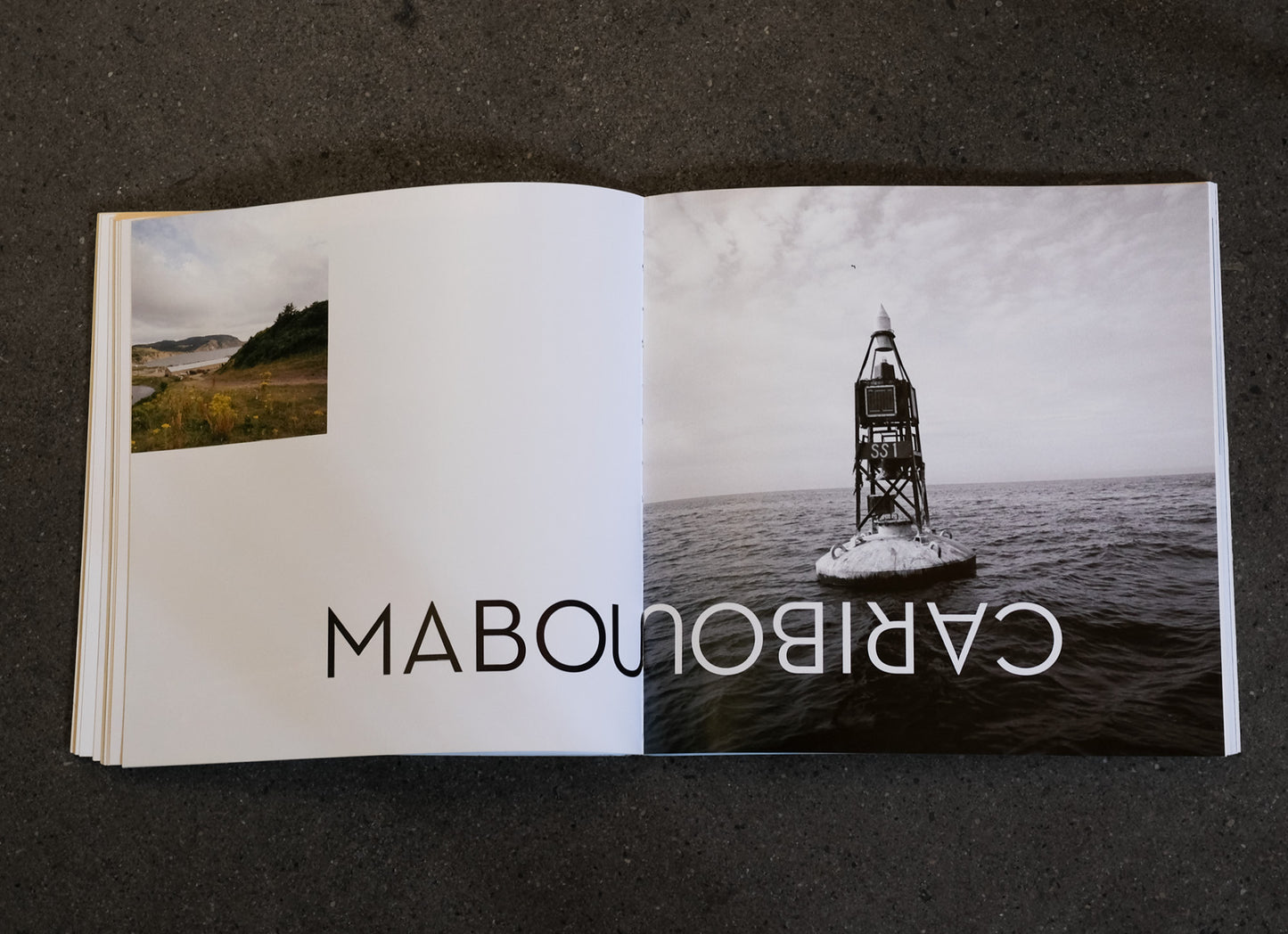 Open book showing a photograph of a lighthouse on an island with 'Mabou' and 'Caribou' text.