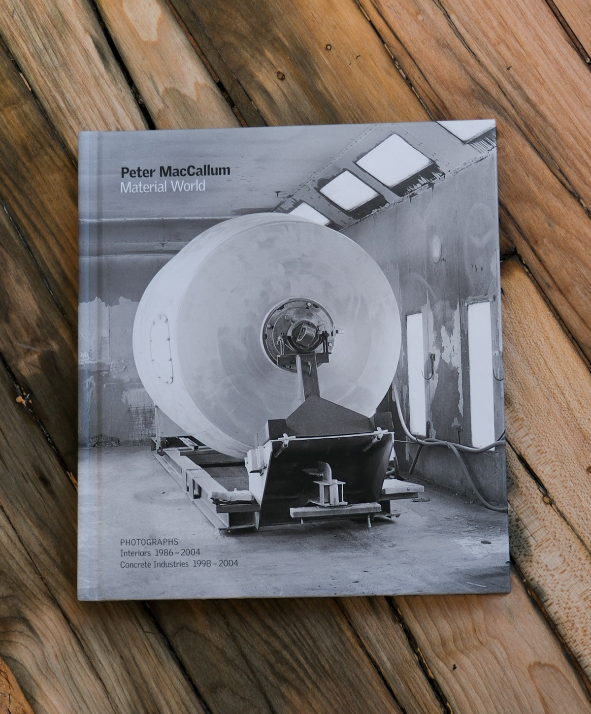 Book titled 'Material World' by Peter MacCallum on a wooden surface