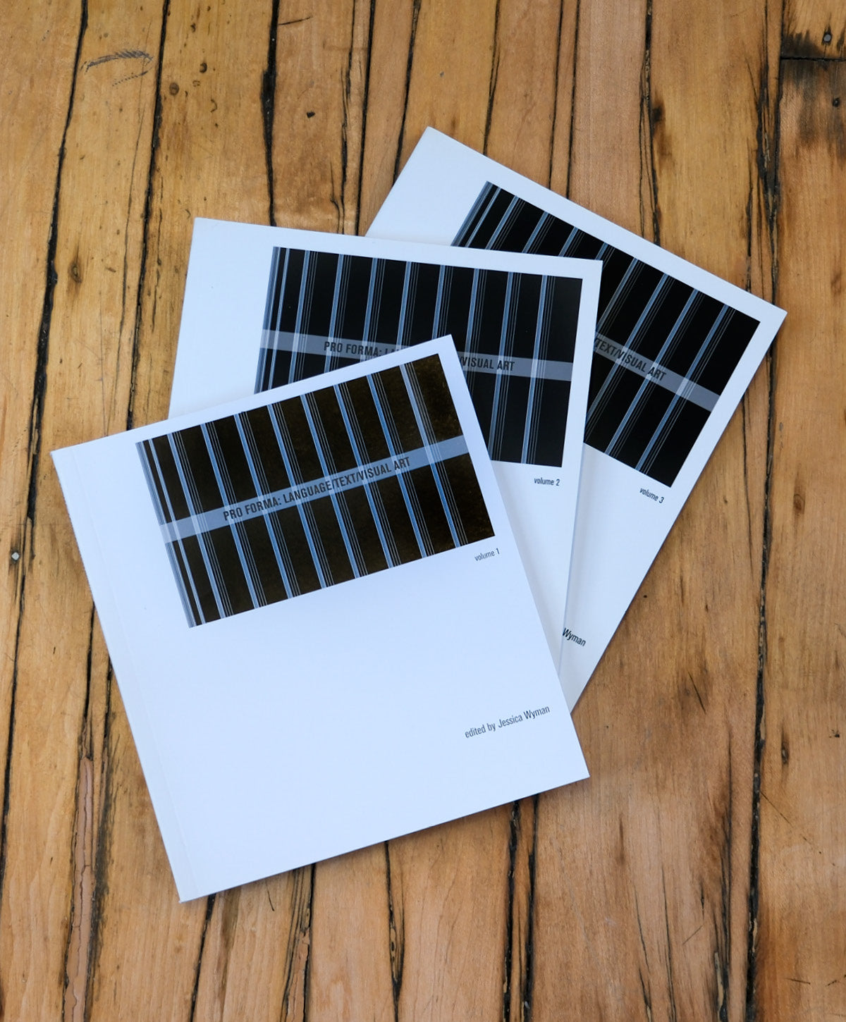 Three black and white prints on a wooden surface