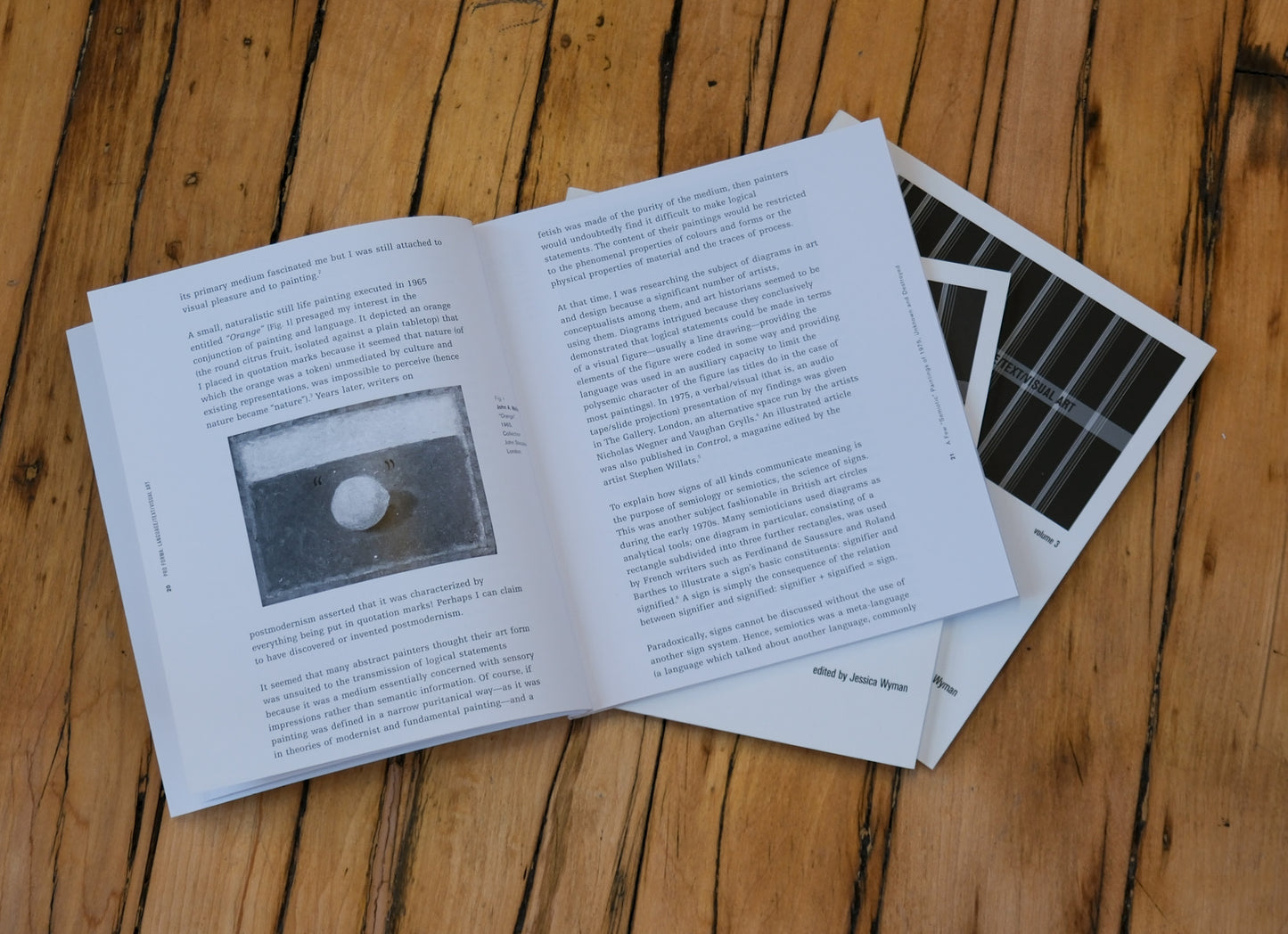 Open book with text and a black and white photo on a wooden surface