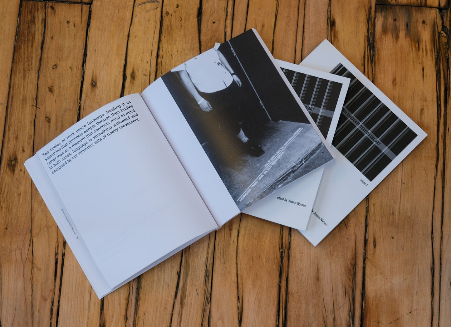 Open book with black and white photographs on a wooden surface