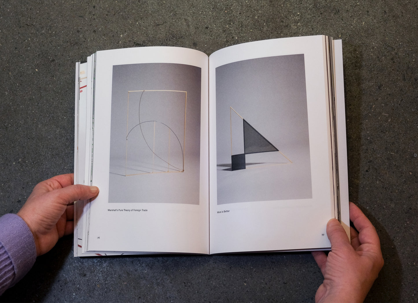 book held open on a concrete surface