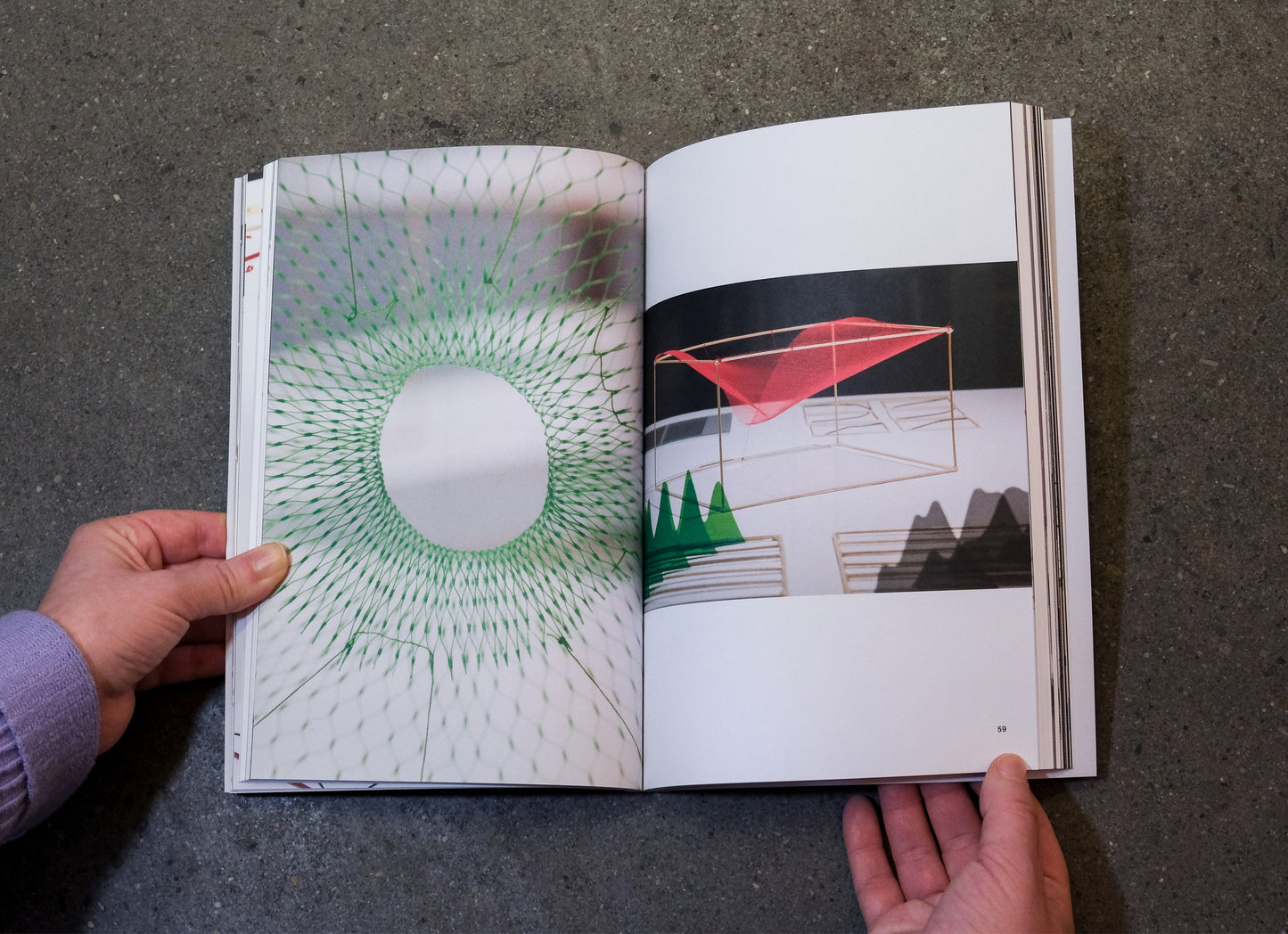book held open on a concrete surface