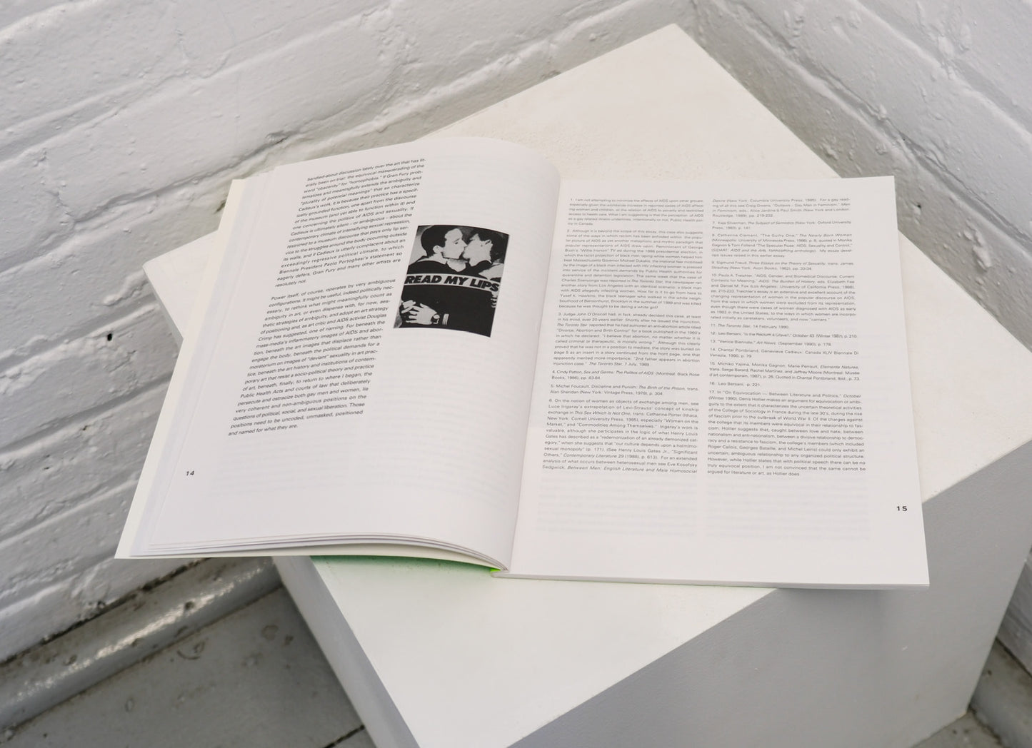 Open book with text and a black and white photo on a white surface.